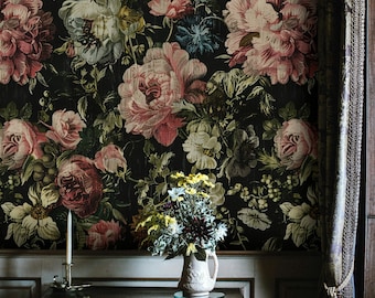 May include: A dark floral wallpaper with a vintage aesthetic, featuring a variety of pink, red, and white flowers on a black background. A small table with a vase of white and yellow flowers sits in front of the wallpaper.