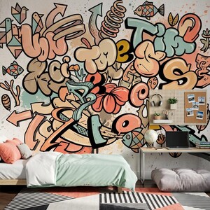 May include: A bedroom with a colorful graffiti mural featuring the word "Time" and other abstract shapes in shades of orange, peach, and teal. The room includes a bed with a light green comforter, a desk, and a patterned rug.