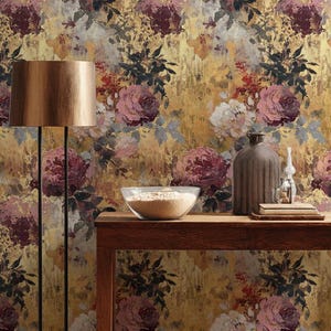 May include: A floral wallpaper with a gold background and large, painterly roses in shades of pink, burgundy, and white. A wooden table displays a bowl, vase, and decorative items. A floor lamp with a gold shade stands to the left.