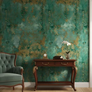 May include: A room featuring a teal and gold textured wall. A dark wood table with a clock, books, and a potted orchid stands before the wall. A teal armchair is on the left side of the image.