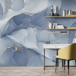May include: A home office with a white desk and a yellow chair. The wall behind the desk is covered in a blue and gold abstract wallpaper.