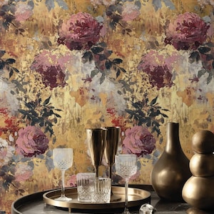May include: An artistic display with a floral wallpaper backdrop featuring large roses in pink, burgundy, and white. A round table holds glassware, gold-toned vases, and a serving tray. The overall aesthetic is elegant and artistic.