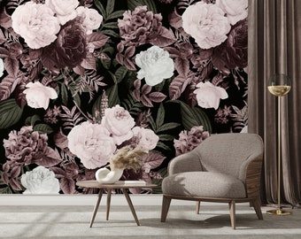 May include: A floral wallpaper with a dark background and pink and white roses. The wallpaper is shown in a room with a brown armchair and a wooden coffee table.