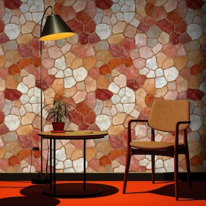 May include: A room featuring a red floor and a wall with a stone pattern. A black lamp with a yellow light, a small round table, a potted plant, and a chair are present. The wall displays a mosaic of red, orange, white, and grey stones.
