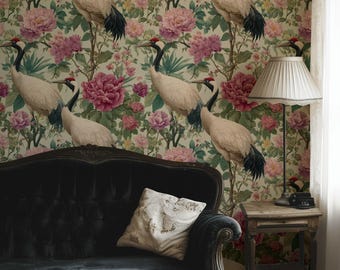 May include: A room featuring a black velvet sofa with a decorative pillow, set against a floral wallpaper with cranes and pink flowers. A small wooden side table with a lamp completes the scene.