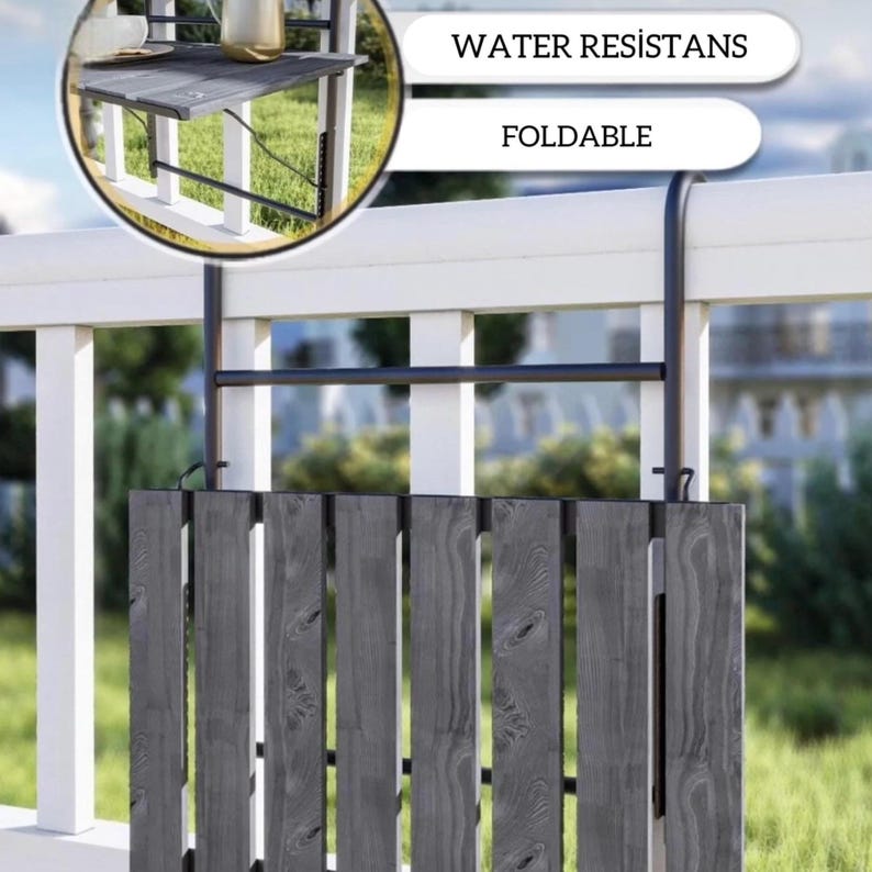 May include: A black folding table with a slatted top is attached to a white wooden fence with black metal brackets. The table is folded down and the text "WATER RESISTANS" and "FOLDABLE" is visible in the image.
