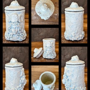 Peut inclure: Un pot cylindrique en c&eacute;ramique avec une finition bleu p&acirc;le textur&eacute;e et un couvercle assorti. L'ext&eacute;rieur pr&eacute;sente un relief sculpt&eacute; repr&eacute;sentant un visage aux cheveux fluides, des croissants de lune et de petites &eacute;toiles.