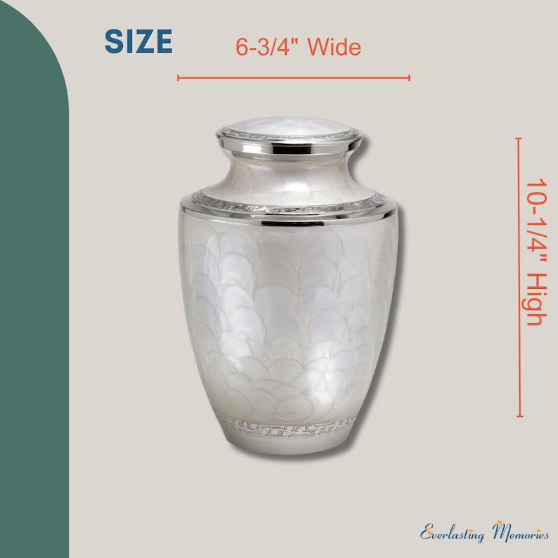 May include: White cremation urn with a silver lid and base. The urn has a textured design and measures 6-3/4 inches wide and 10-1/4 inches high.