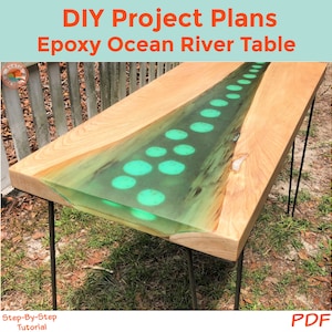 May include: DIY project plans for an epoxy ocean river table. The table has a wooden top with a clear epoxy river running down the center. The river is filled with green circles that resemble bubbles. The table is supported by four black hairpin legs.