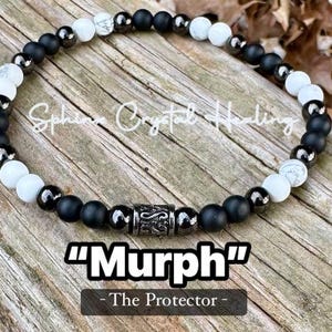 May include: A black and white beaded bracelet with a silver charm that says "Murph" - The Protector.