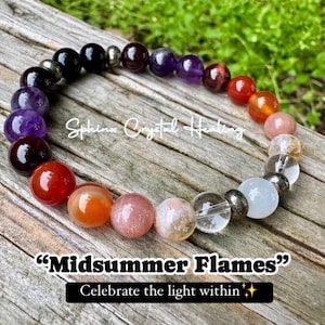 May include: A colorful beaded bracelet with a rainbow of colors, including purple, red, orange, yellow, and white. The bracelet is made with natural stones and has a silver metal clasp. The text "Midsummer Flames" and "Celebrate the light within" is printed below the bracelet.