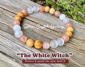 May include: A beaded bracelet featuring alternating round beads in translucent white, smooth peach, and textured light brown wood. The image includes the text "Sphinx Crystal Healing", "The White Witch", and "Protect & purify the auric field".