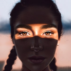 May include: A close-up portrait of a person with dark hair and brown eyes. The person is looking directly at the camera. A beam of light shines across the person's face, highlighting their eyes.