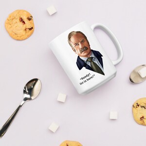 May include: White ceramic mug with a cartoon illustration of a man with a mustache and the text "Randy! Get in here!" printed on it.