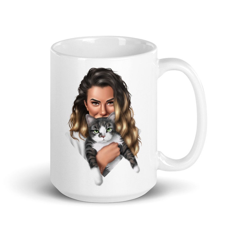 May include: White ceramic mug with a colorful illustration of a woman with long blonde hair holding a gray and white cat.