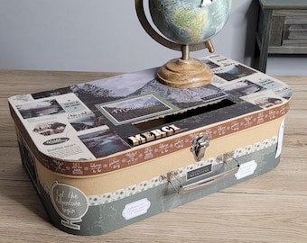 Suitcase-shaped money box with a mountain travel theme