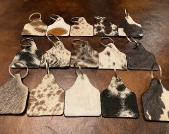 100% Real Brazilian hanging Cowhide Tag keychain With leather backing- black and white, solid black, solid brown, and gray and white