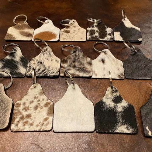 100% Real Brazilian hanging Cowhide Tag keychain With leather backing- black and white, solid black, solid brown, and gray and white