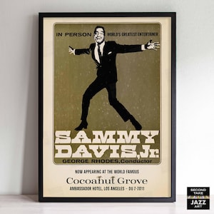 May include: A vintage concert poster advertising Sammy Davis Jr. performing at the Cocoanut Grove in Los Angeles. The poster features a silhouette of Sammy Davis Jr. in a suit, with the text "In Person", "World's Greatest Entertainer", "Sammy Davis Jr.", "George Rhodes, Conductor", "Now Appearing at the World Famous Cocoanut Grove", "Ambassador Hotel, Los Angeles - DU 7-7011" and "Second Take Jazz Art".