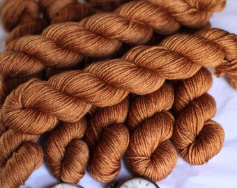 Bronze on superwash merino worsted/ DK weight yarn , hand dyed in small batches in the uk