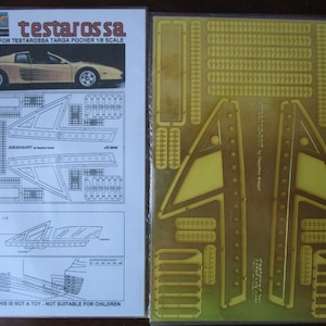 May include: A detail set for a 1/8 scale model of a Ferrari Testarossa Targa. The set includes a sheet of photo-etched parts, a sheet of instructions, and a sheet of extra parts. The photo-etched parts are made of thin metal and are used to add detail to the model. The instructions are printed on a sheet of paper and show how to assemble the parts. The extra parts are made of plastic and are used to add detail to the model.