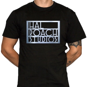 May include: Black t-shirt with a silver metallic print of "Hal Roach Studios" on the front.