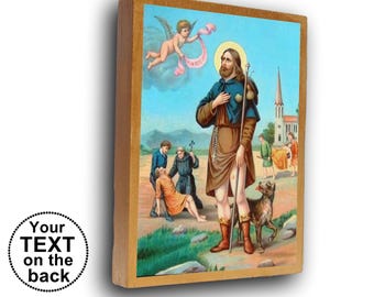 May include: A rectangular wooden plaque featuring a religious illustration of a bearded figure in a brown tunic and blue cloak holding a staff, accompanied by a dog, with a small angel above and figures in the background. Text reads: Your TEXT on the back.