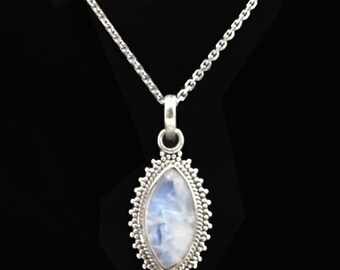May include: A silver chain necklace with a silver pendant featuring a moonstone oval cabochon set in a beaded border.