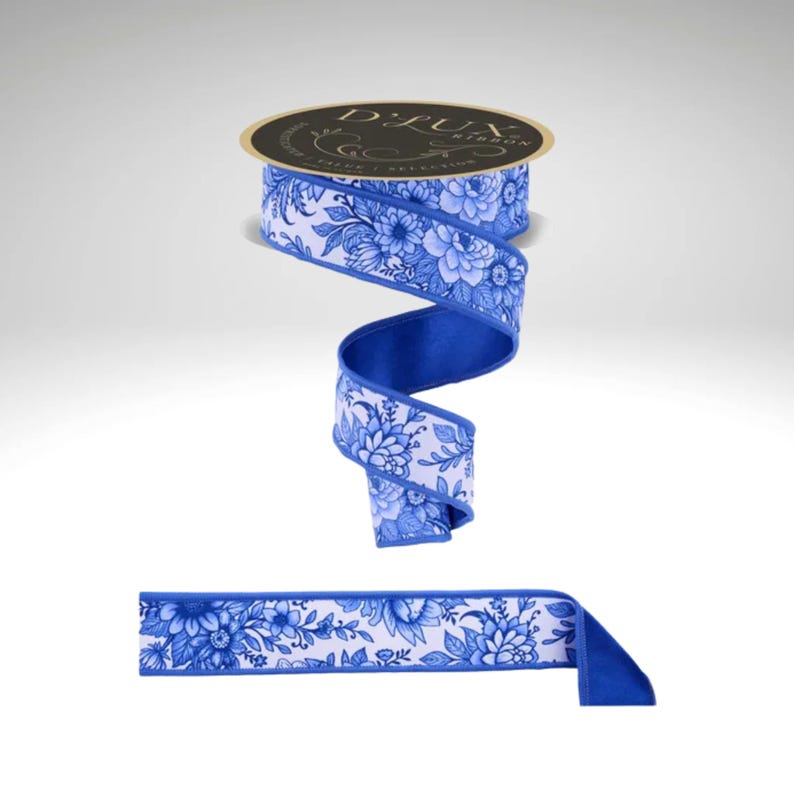 May include: A roll of D.Lux ribbon with a blue and white floral pattern. The ribbon is unrolled to show the blue backing and the floral design. The ribbon is suitable for gift wrapping, crafts, and decorations.