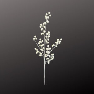 May include: A single, artificial stem with small, round, off-white berries. The stem is a pale silver color, and the berries are clustered along the branches. The background is a dark gray.