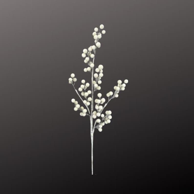 May include: A single, artificial stem with small, round, off-white berries. The stem is a pale silver color, and the berries are clustered along the branches. The background is a dark gray.