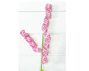 May include: A pink and white checkered ribbon is curled into a spiral shape on a green stem. The ribbon is about 18 inches long.