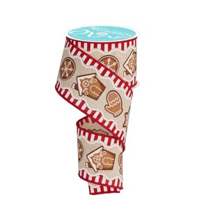 May include: A roll of decorative ribbon featuring a festive gingerbread theme. The ribbon has a tan background with repeating patterns of gingerbread houses, snowflakes, and mittens. The edges are trimmed with a red and white striped border. The spool is teal with white text.