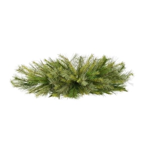 May include: A green and yellow artificial pine needle arrangement. The decorative piece is oval-shaped and appears to be made of plastic. The needles are a mix of light and dark green, with some yellow tips. The background is white.