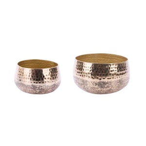 May include: Two decorative metal bowls with a hammered texture. The bowls have a gold interior and a silver-gold exterior. The bowls are round and have a low profile, suitable for holding small items or as decorative accents.