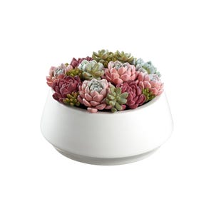 May include: A white ceramic planter filled with a variety of colorful faux succulents. The succulents are in shades of pink, green, and burgundy. The planter has a modern, rounded shape.