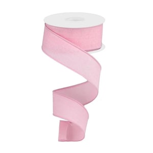 May include: A roll of light pink ribbon with a textured appearance. The ribbon is unwound, creating a flowing, decorative element. The ribbon is likely used for crafts, gift wrapping, or other decorative purposes.
