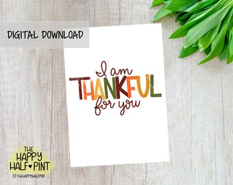May include: A printable card with the text "I am thankful for you" in colorful, stylized lettering. The letters are in shades of orange, red, green, and brown.