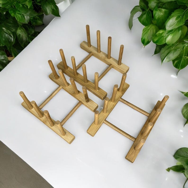 May include: A wooden dish drying rack with multiple slots for plates and bowls. The rack is made of natural bamboo and has a light brown color.