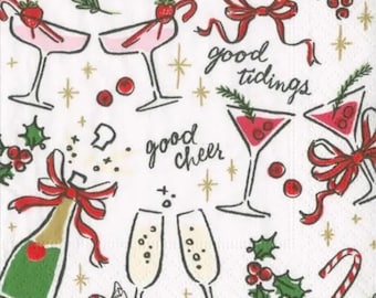 May include: White cocktail napkins with a festive design. The napkins feature illustrations of champagne glasses, cocktails, candy canes, holly, and red bows. The words "good tidings" and "good cheer" are written on the napkins.