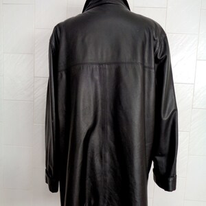 May include: A black leather jacket with a collar and long sleeves.