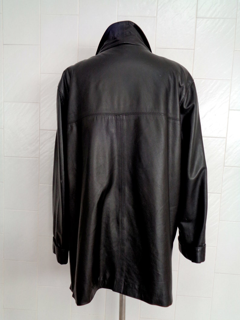 May include: A black leather jacket with a collar and long sleeves.
