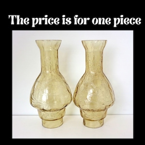 May include: Two amber-colored glass vases with a textured surface. The vases have a bulbous body and a flared top. The text "The price is for one piece" is displayed at the top of the image.