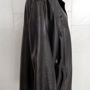 May include: A black leather jacket with a collared neckline and a long sleeve. The jacket has a zipper closure and two pockets.
