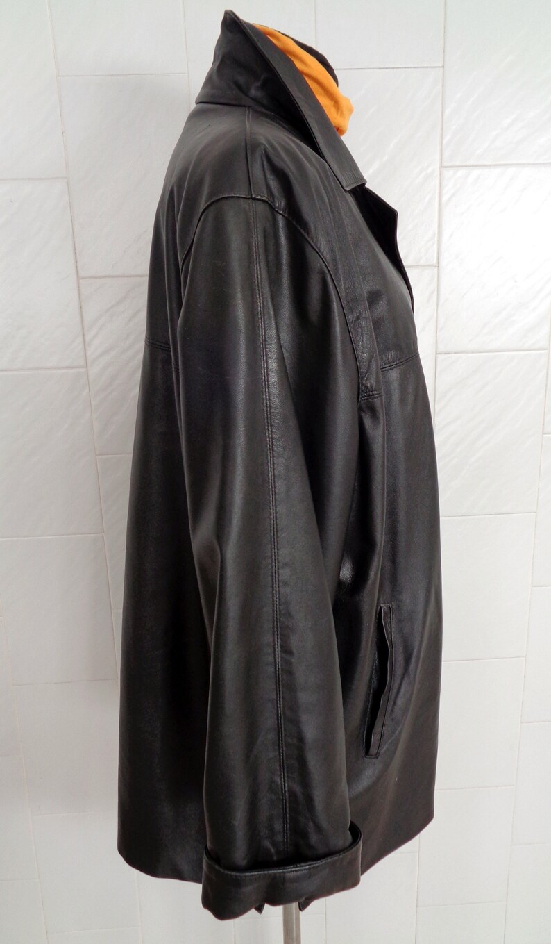 May include: A black leather jacket with a collared neckline and a long sleeve. The jacket has a zipper closure and two pockets.