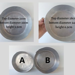 May include: Two aluminium pans with handles are shown. One has a top diameter of 23cm, bottom diameter of 20cm, and a height of 5.5cm. The other pan has a top diameter of 28cm, bottom diameter of 24cm, and a height of 6.5cm. Pans are labelled A and B.