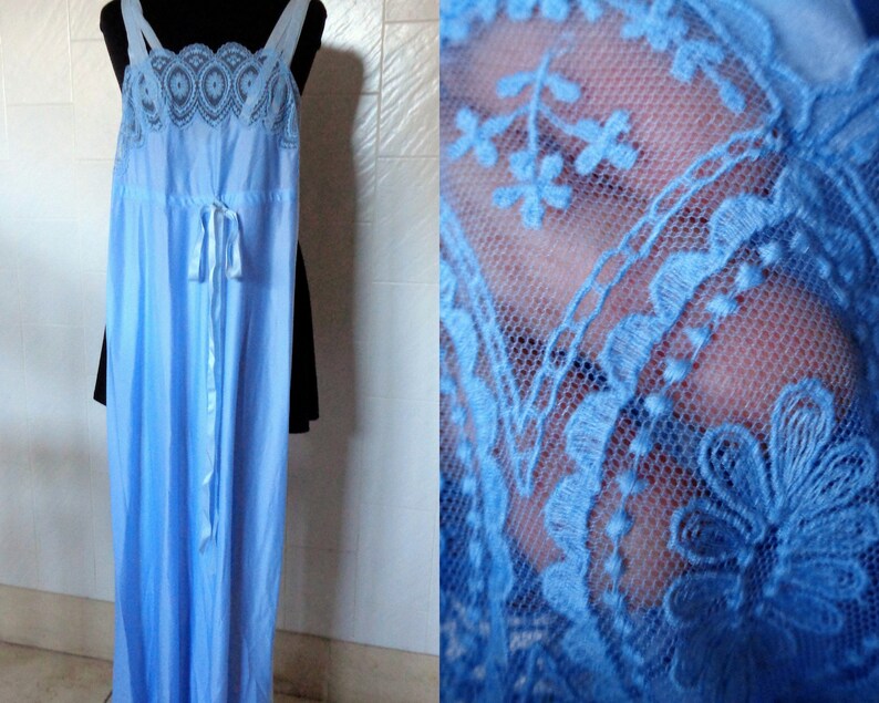 May include: A light blue, floor-length slip dress with delicate lace trim around the neckline and straps. The dress has a tie at the waist.