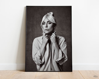 May include: Black and white portrait photograph of a woman with blonde hair styled in a bun. She is wearing a light-colored button-down shirt and has a serious expression on her face.