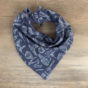 May include: A dark blue bandana with a white pattern of various tools, including drills, wrenches, and saws.