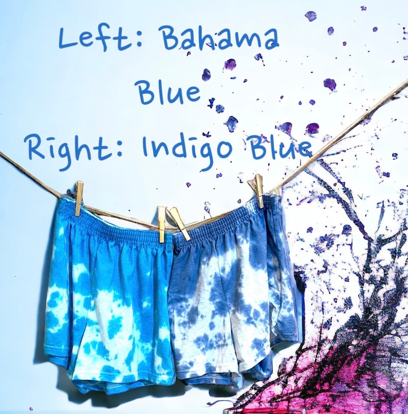 May include: Two pairs of tie-dye shorts hanging on a clothesline. The shorts on the left are a lighter blue color, labeled "Bahama Blue". The shorts on the right are a darker blue color, labeled "Indigo Blue".